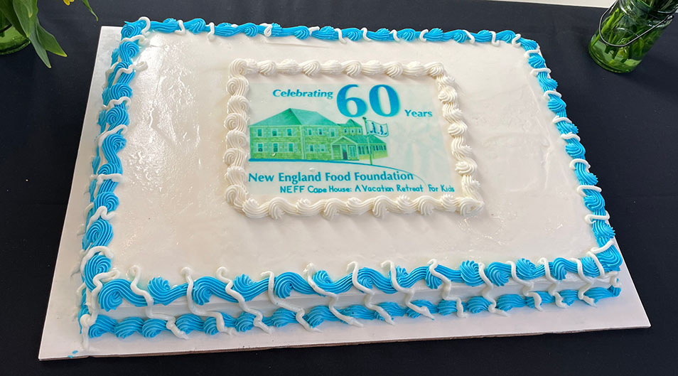 large sheet cake with image of NEFF cape house and text "Celebrating 60 Years"